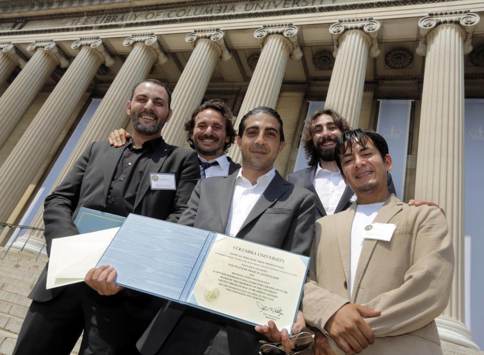 The Associated Press 2013 Pulitzer Prize-winning team, whose coverage of the Syrian civil war won the prize for Breaking News Photography, pose together after the awards ceremony on the steps of Columbia University's Low Library, in New York, Thursday, May 30, 2013. From left are: Gaza-based Khalil Hamra, Rodrigo Abd of Guatemala, Pakistan chief photographer Muhammed Muheisen, Manu Brabo of Spain and Narciso Contreras of Mexico. (AP Photo/Richard Drew)