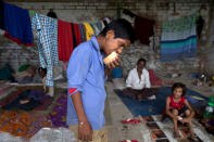 <p>A boy eats bread in a temporary relief camp made in a school in Varanasi, India, Friday, Aug. 26, 2016. (AP Photo/Tsering Topgyal)</p>