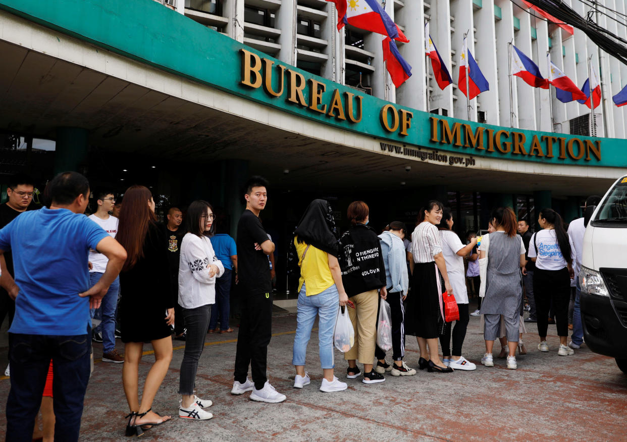 File Photo: Chinese nationals queue outside the Bureau of Immigration in Manila, Philippines, June 13, 2019. REUTERS/Eloisa Lopez