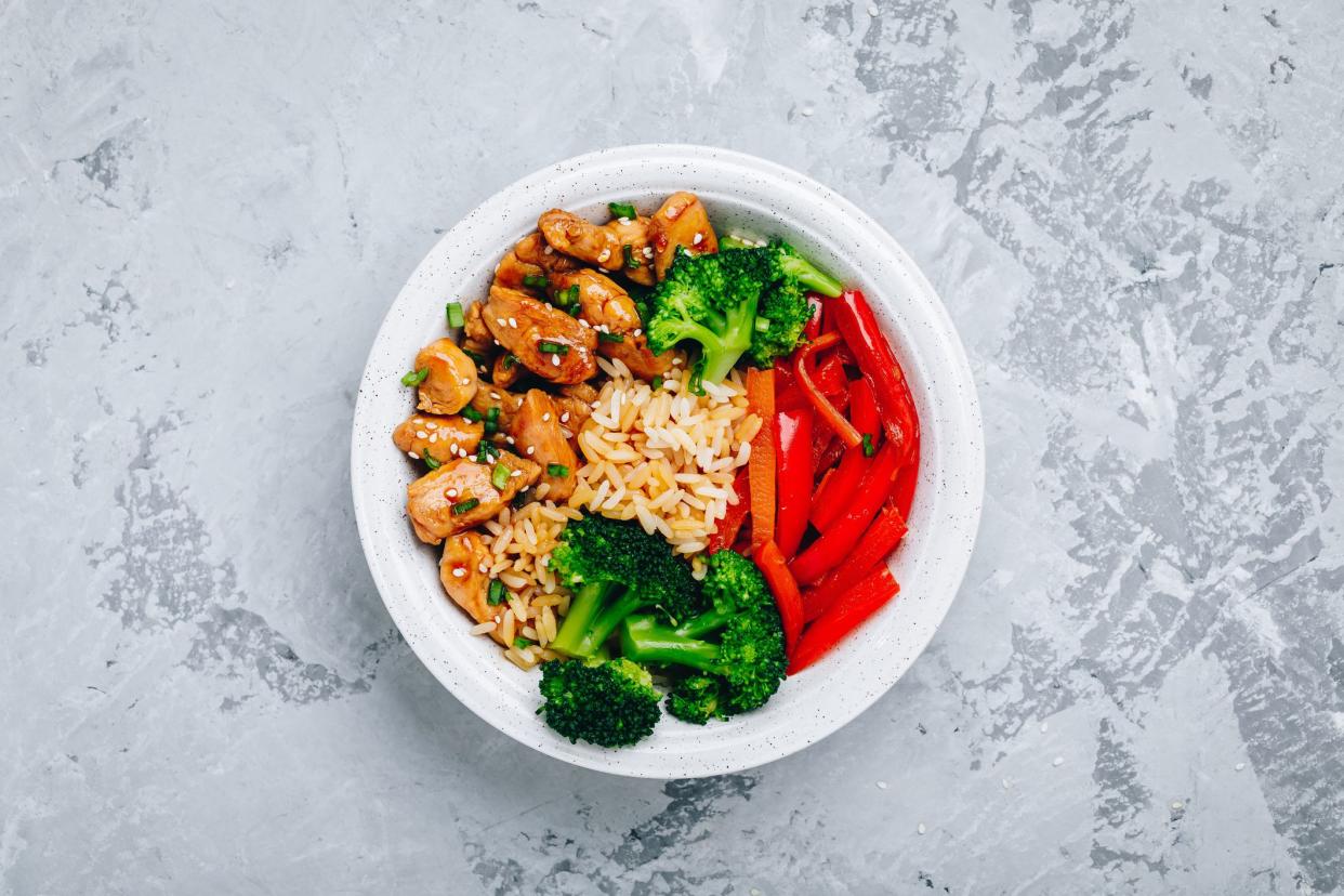 Teriyaki Chicken buddha bowl lunch with rice, broccoli, carrots and red bell pepper