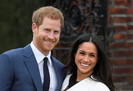 Britain's Prince Harry poses with Meghan Markle in the Sunken Garden of Kensington Palace, London, Britain, November 27, 2017. REUTERS/Toby Melville