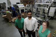 In this Friday, July 5, 2019, file photo Achyut Patel, Director of Operations, Rudy Patel, Director of Business Development an Katrina Hart, business development coordinator pose for a picture at beyond Green, a maker of biodegradable bags in Lake Forest, Calif. (AP Photo/Chris Carlson)