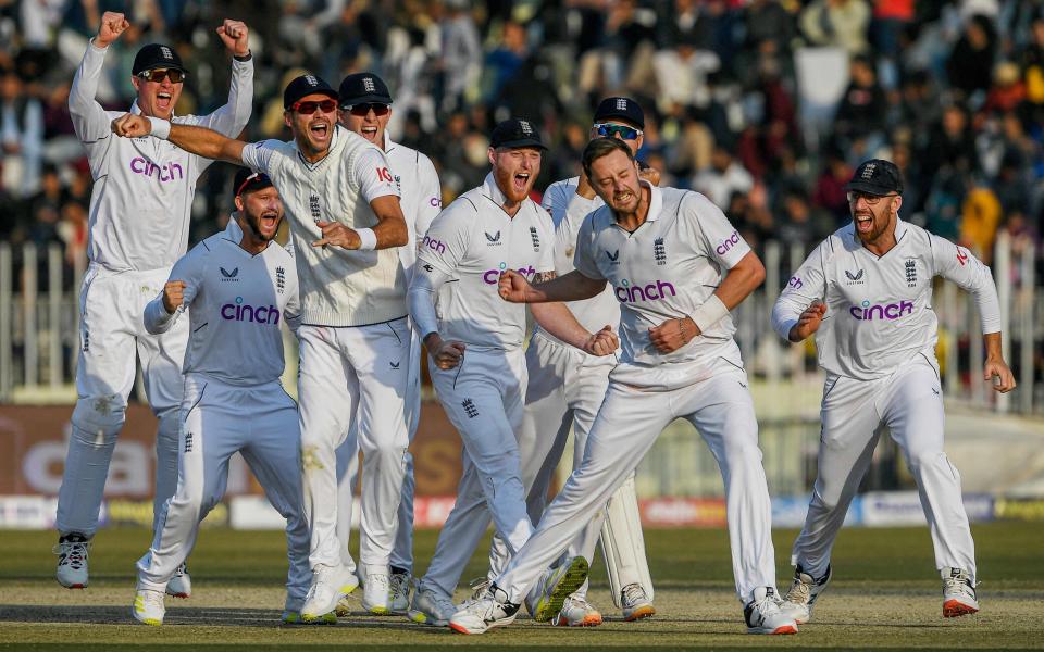 England's players celebrate after the dismissal of Pakistan's Salman Ali Agha (not pictured) during the fifth and final day of the first cricket Test match between Pakistan and England at the Rawalpindi Cricket Stadium - AFP