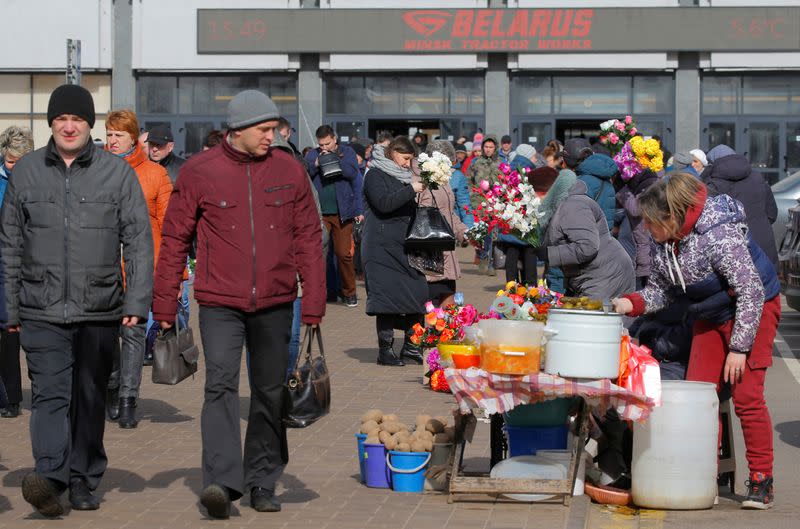 Women sell vegetables and artificial flowers at an illegal market amid coronavirus disease (COVID-19) outbreak