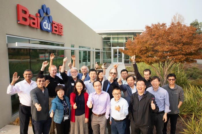 Baidu's research advisory board posing happily in front of a Baidu building.