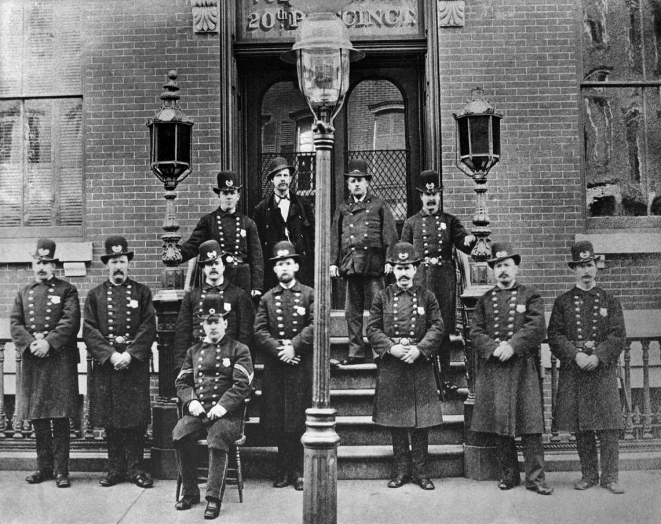 <p>Officers of the New York Police Department's 20th Precinct pose as a unit outside of their station. </p>