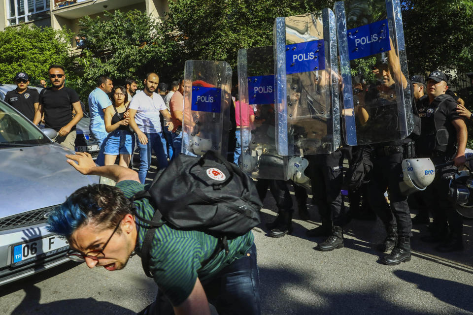 FILE - Protesters clash with Turkish police during the LGBTQ Pride March in Ankara, Turkey, Tuesday, July 5, 2022. Police in Turkey's capital broke up the march and detained dozens of people. President Recep Tayyip Erdogan’s government has shown increasing intolerance toward any expression of LGBTQ rights, banning Pride marches and suppressing the display of rainbow symbols. (AP Photo/Ali Unal, File)