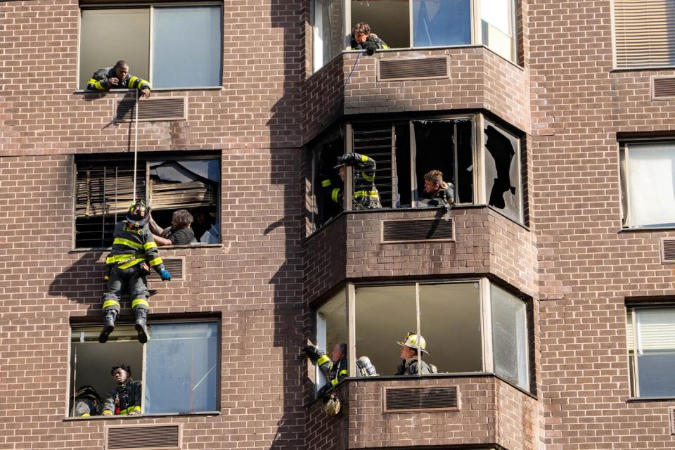 Firefighters perform a rope rescue after a fire broke out inside a high-rise building on East 52nd Street in Manhattan on Saturday, Nov. 5, 2022, in New York.