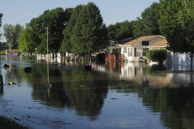 <p> Jerry Mennenga/ZUMA Press Wire/Shutterstock</p> A residential street is flooded in Sioux City on June 24, 2024