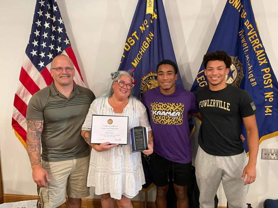 Fowlerville Junior High School Teacher Michelle Spisz, center, is named Teacher of the Year on Saturday, July 22, 2023. She is pictured with her husband, Jon, and sons Lorenzo and Justice.