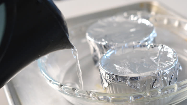 Water being poured into a bain-marie