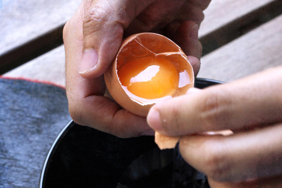 Add the eggs one at a time, breaking them first into a small bowl to catch any broken shell.