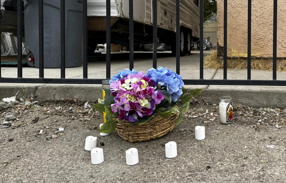 A makeshift memorial for a high school student lines a fence along an alleyway near Rancho High School in eastern Las Vegas on Wednesday, Nov. 15, 2023. Authorities arrested eight teens Tuesday in connection with the beating of Jonathan Lewis Jr., who died a week after a prearranged fight over a pair of headphones and a vape pen. (AP Photo/Rio Yamat)