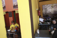 In this April 25, 2019, photo, customers eat lunch in Little Habana restaurant in Ciudad Juarez, Mexico. About 4,500 people, the vast majority of them Cubans, are on a waiting list for asylum interviews in the U.S. and are biding their time time in Ciudad Juarez. The influx has transformed the city across from El Paso, Texas. (AP Photo/Christian Torres)