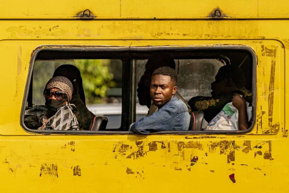 People watch as Secretary of State Antony Blinken's motorcade moves through Kinshasa, Congo, Tuesday, Aug. 9, 2022. Blinken is on a ten day trip to Cambodia, Philippines, South Africa, Congo, and Rwanda. (AP Photo/Andrew Harnik, Pool)