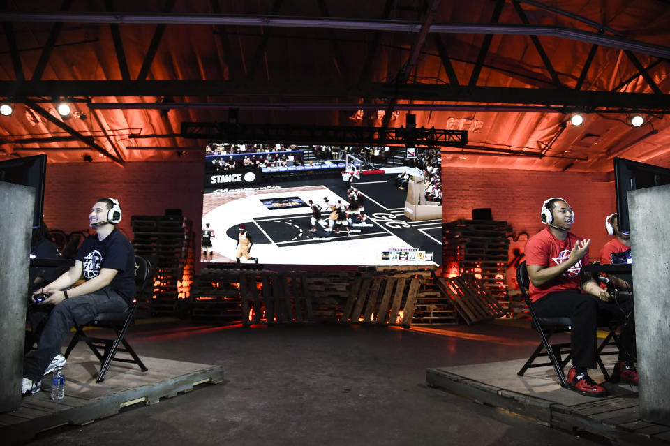 Team GFG (right) and Team Drewkerbockers (left) compete at the “NBA 2K16” Road to the Finals championship event on June 1, 2016, in Los Angeles. Two teams of gamers went head-to-head for a shot at $250,000 and a trip to the 2015-2016 NBA Finals. (Dan Steinberg/Invision for NBA 2K/AP)