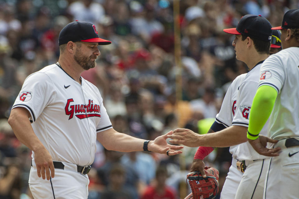 Cleveland Guardians manager Stephen Vogt, left, takes the ball from starter Logan Allen during the fifth inning of a baseball game against the San Francisco Giants in Cleveland, Saturday, July 6, 2024. (AP Photo/Phil Long)