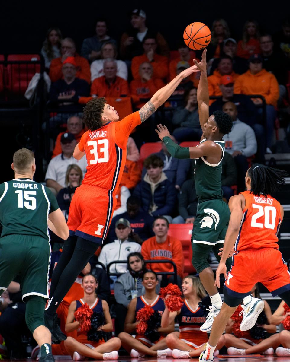 Illinois' Coleman Hawkins (33) blocks the shot of Michigan State's Tyson Walker during the first half at State Farm Arena in Champaign, Illinois, on Thursday, Jan. 11, 2024.