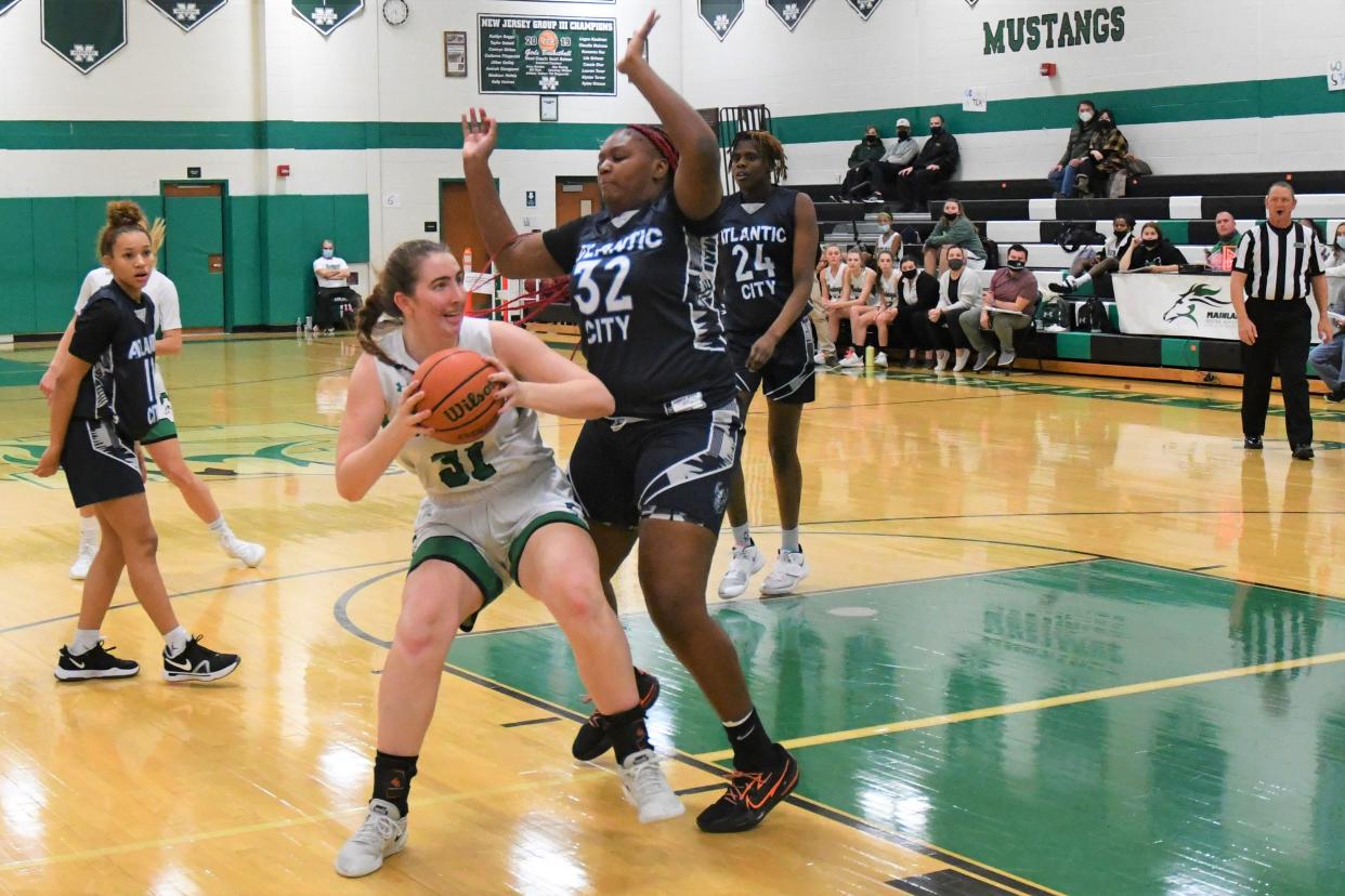 Mainland senior Kaitlyn Boggs pump fakes Atlantic City center Cea-Anni Jackson-Williams