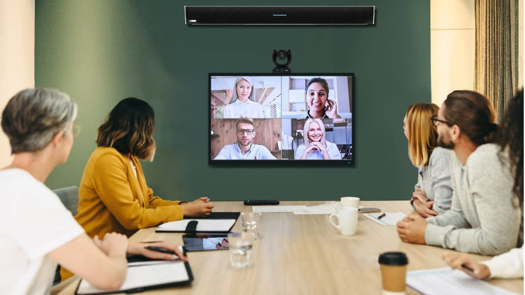  People in a conference room using an AVer and Nureva meeting room hybrid bundle.  