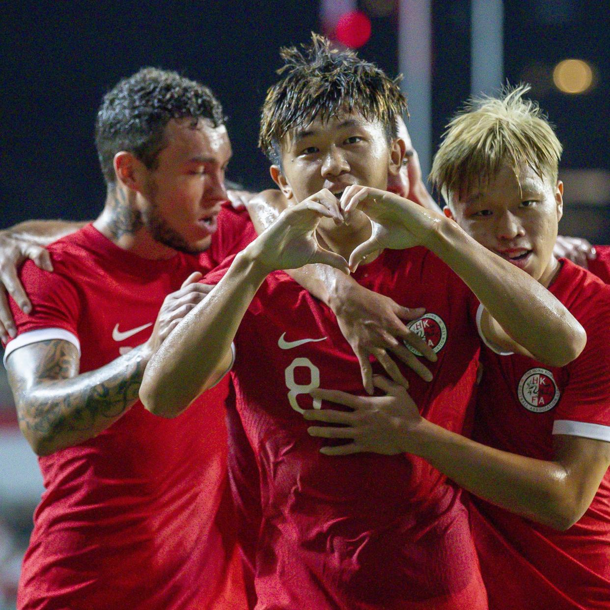 Hong Kong footballers celebrate a goal