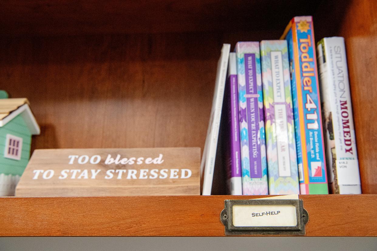 Books line a shelf in a computer room at ABCCM Transformation Village in Asheville, April 11, 2024.