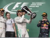 Oct 23, 2016; Austin, TX, USA; Mercedes driver Lewis Hamilton (44) of Great Britain drinks champagne from the trophy after he wins the United States Grand Prix at the Circuit of the Americas. Mandatory Credit: Jerome Miron-USA TODAY Sports