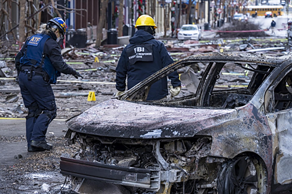 In this photo provided by the FBI and Bureau of Alcohol, Tobacco, Firearms and Explosives, FBI and ATF Evidence Response Teams process the scene, Monday, Dec. 28, 2020, of the Christmas Day blast in Nashville, Tenn. The teams are searching for evidence to assist in the ongoing investigation. (FBI/ATF via AP)