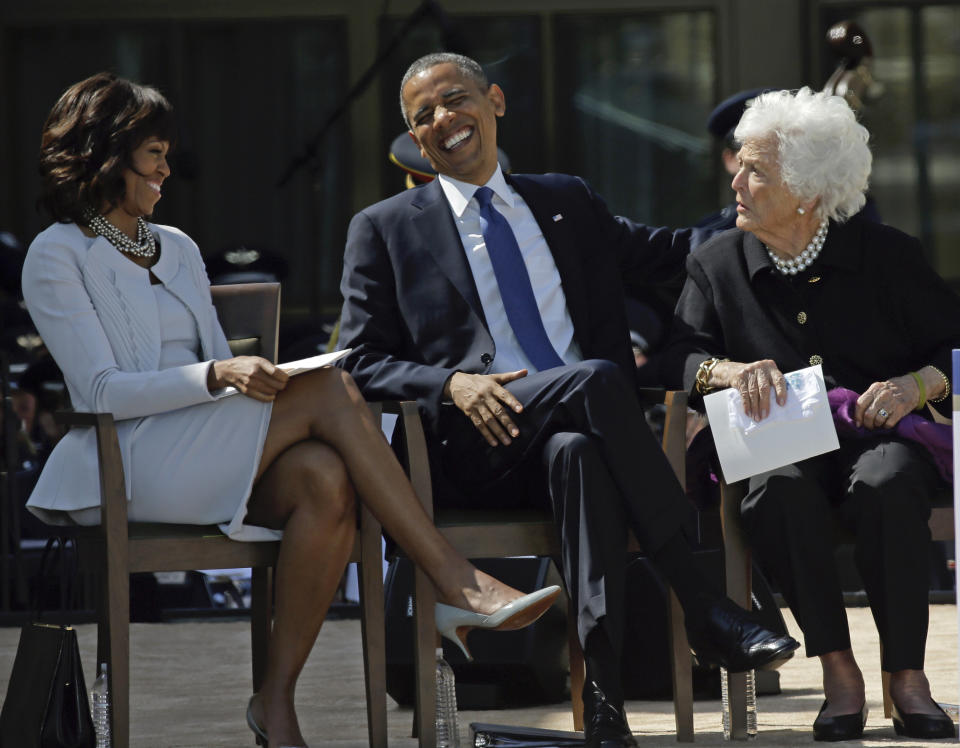 President Barack Obama laughs as he sits between his wife, first lady Michelle Obama and former first lady Barbara Bush after his speech during the dedication of the George W. Bush presidential library on Thursday April 25, 2013, in Dallas. (AP Photo/David J. Phillip)