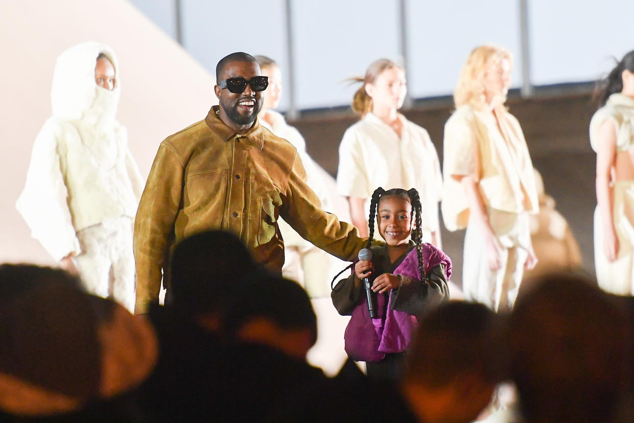 Kanye West and his daughter North West at the Paris catwalk show of his Yeezy collection in March 2020. (Getty Images)