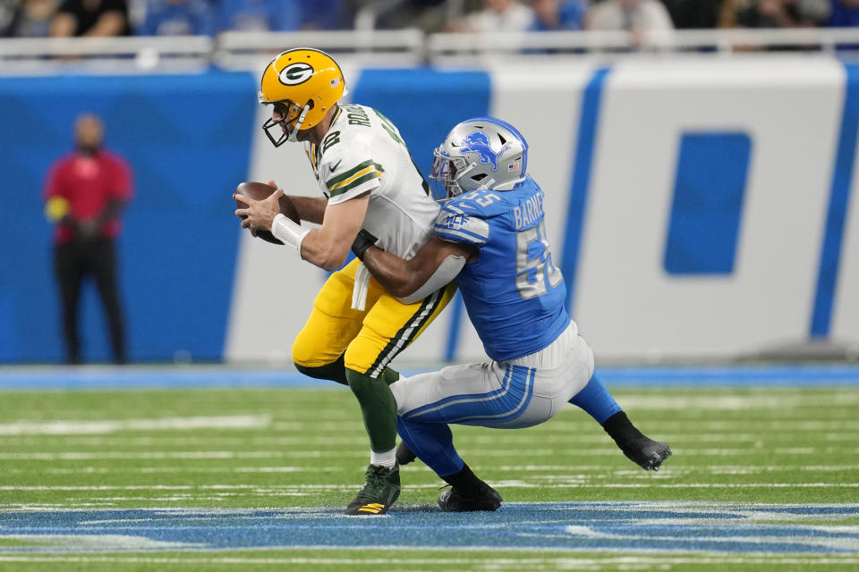 Green Bay Packers quarterback Aaron Rodgers (12) is sacked by Detroit Lions linebacker Derrick Barnes (55) during the first half of an NFL football game, Sunday, Nov. 6, 2022, in Detroit. (AP Photo/Paul Sancya)