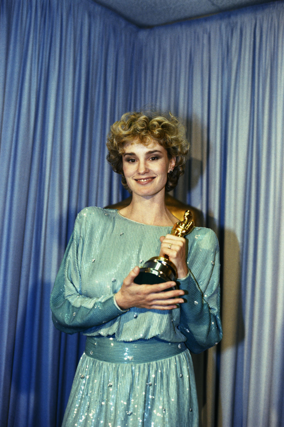 (Original Caption) Hollywood, California: Actress Jessica Lange stands backstage at the 1982 Academy Awards Ceremony holding the Oscar that she won for Best Actress in a Supporting Role for her role in Tootsie.