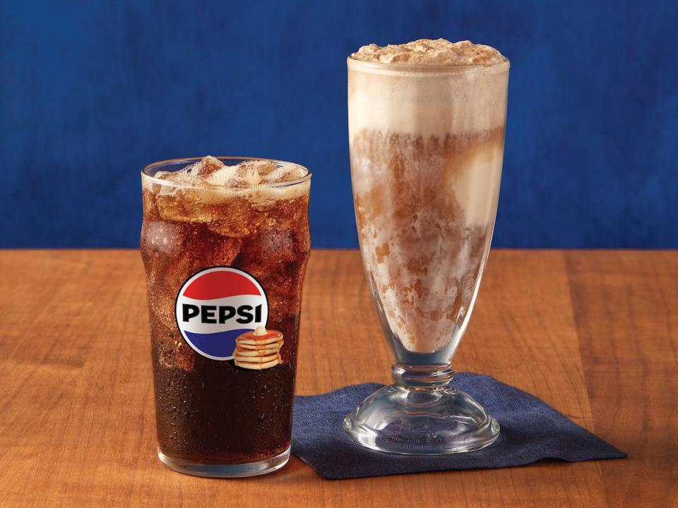 A glass of IHOP Pepsi Maple Syrup Cola next to an ice cream float glass