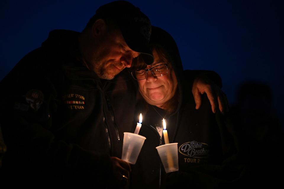 <p>Joshua Lott/The Washington Post via Getty</p> People mourn in Perry, Iowa, on Jan. 4.