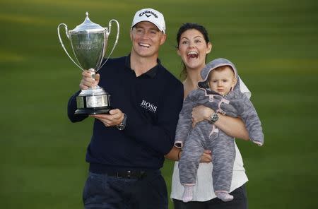 Britain Golf - British Masters - The Grove, Hertfordshire - 16/10/16 Sweden's Alex Noren celebrates winning the British Masters with his wife Jennifer Kovacs and child Action Images via Reuters / Paul Childs Livepic EDITORIAL USE ONLY.