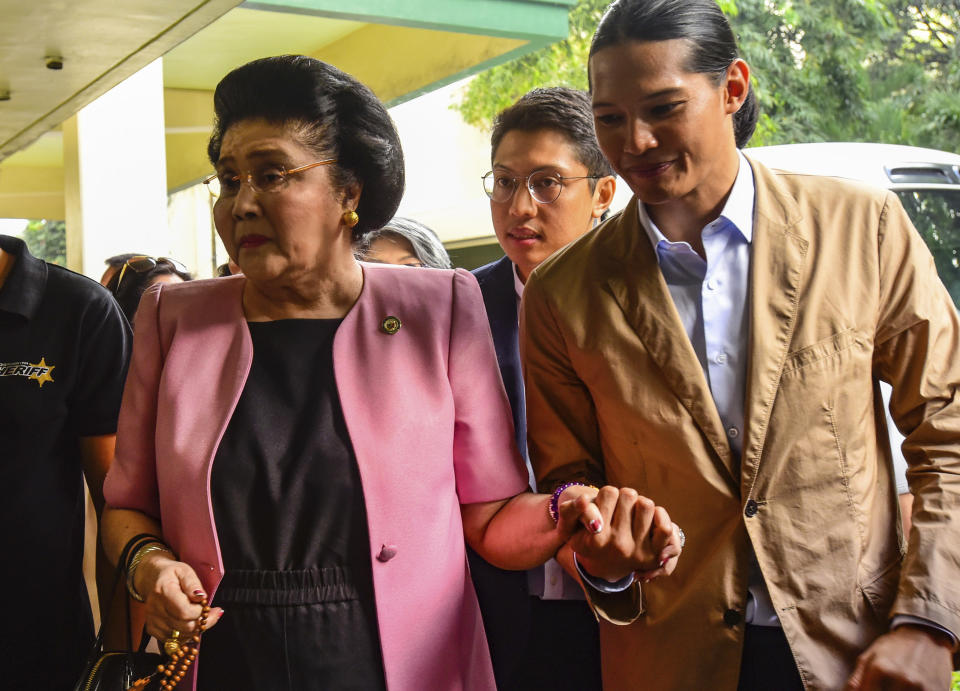 Former Philippine First Lady Imelda Marcos arrives at an anti-graft court Sandiganbayan to explain her side for not attending last week's promulgation of the graft charges against her Friday, Nov. 16, 2018 in suburban Quezon city northeast of Manila, Philippines. A Philippine court found Imelda Marcos guilty of graft and ordered her arrest last week in a rare conviction among many corruption cases that she's likely to appeal to avoid jail and losing her seat in Congress. (AP Photo/Maria S. Tan)