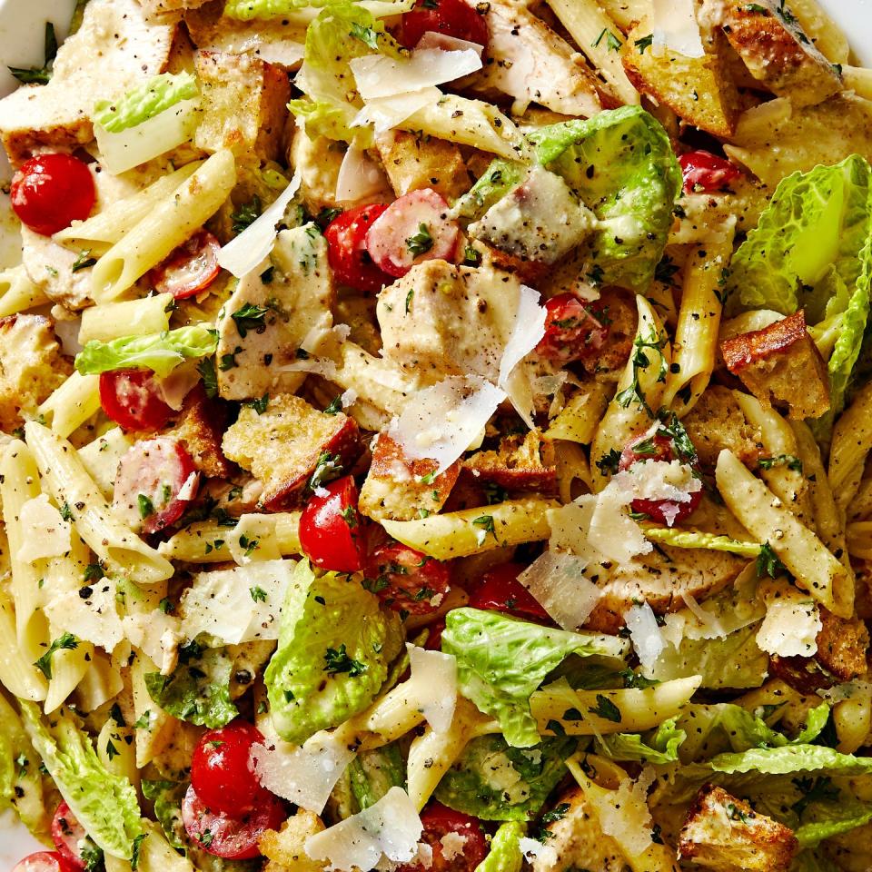 chicken caesar pasta salad with chicken, tomatoes, penne pasta, and parmesan all tossed in creamy caesar dressing