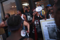 <p>Demonstrators rally outside the Sideline Studio Barber & Beauty Salon in the South Shore neighborhood protesting the shooting death of 37-year-old Harith Augustus who worked there as a barber on July 16, 2018 in Chicago, Ill. Augustus was shot and killed on July 14 by a Chicago police officer following a brief altercation. Two people were shot a block from where Augustus was killed less than an hour before tonight’s protest began. (Photo: Scott Olson/Getty Images) </p>