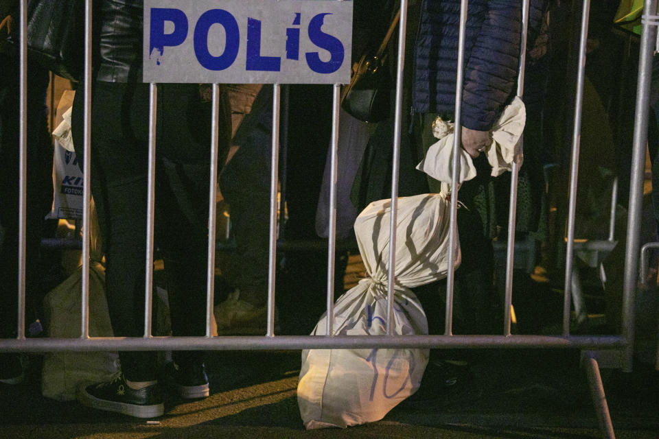 Polling station officials wait with bags containing ballots outside the Supreme Electoral Board office in Diyarbakir, Turkey, early Monday, May 15, 2023. Turkey’s presidential elections appeared to be heading toward a second-round runoff on Monday, with President Recep Tayyip Erdogan, who has ruled his country with a firm grip for 20 years, leading over his chief challenger, but falling short of the votes needed for an outright win. (AP Photo/Metin Yoksu)