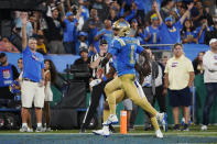 UCLA quarterback Dorian Thompson-Robinson (1) scores a rushing touchdown against Washington during the second half of an NCAA college football game Friday, Sept. 30, 2022, in Pasadena, Calif. (AP Photo/Marcio Jose Sanchez)