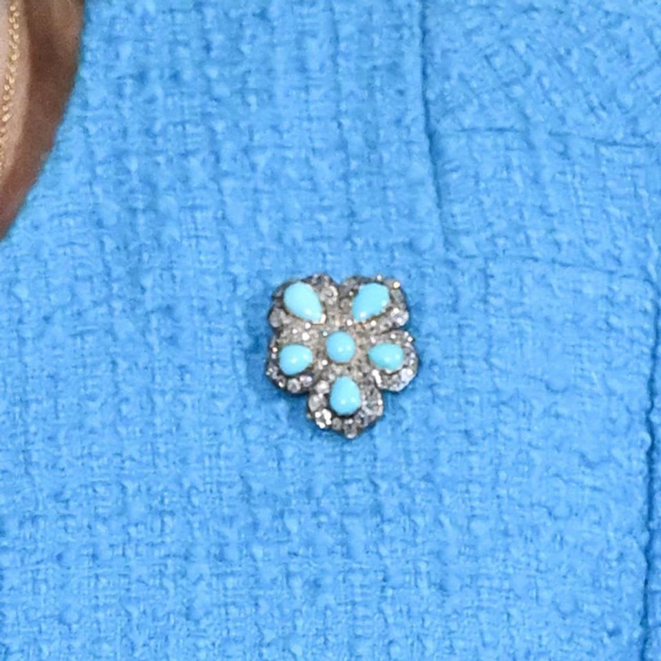 A close up look at the turquoise and diamond brooch