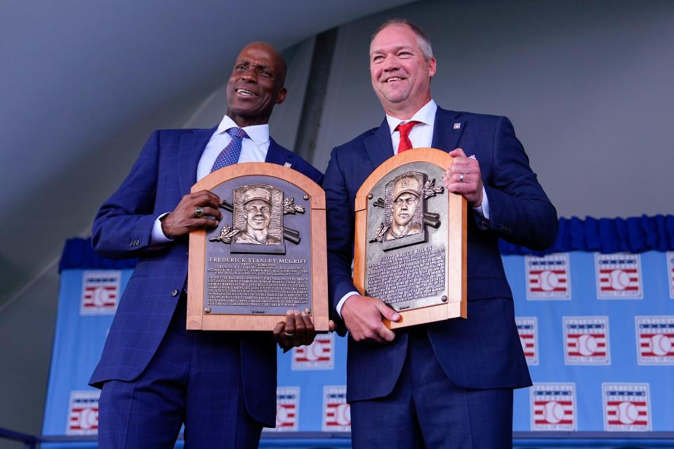 Fred McGriff, left, Scott Rolen pose for a photo with their new plaques after being inducted into the National Baseball Hall of Fame.