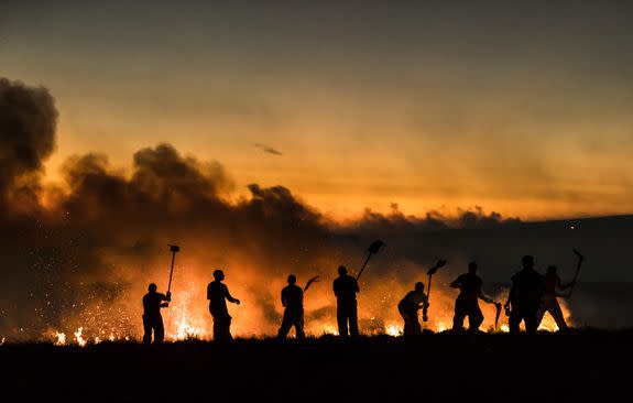 Firefighters tackle a wildfire on Winter Hill near Bolton. (Photo by Danny Lawson/PA Images via Getty Images)