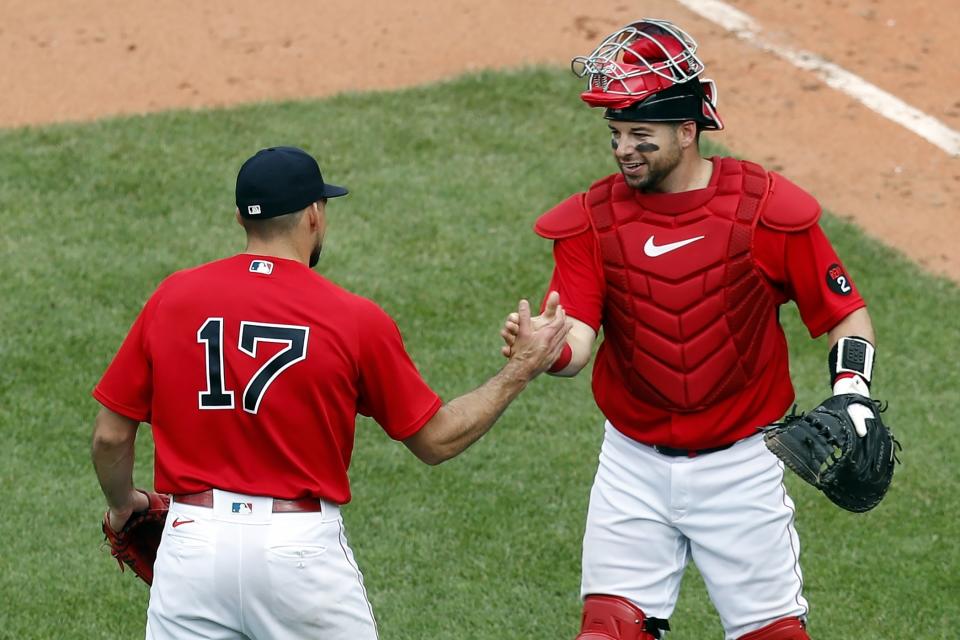 Boston Red Sox's Nathan Eovaldi (17) and Kevin Plawecki celebrate after defeating the Baltimore Orioles during the first game of a baseball doubleheader, Saturday, May 28, 2022, in Boston. (AP Photo/Michael Dwyer)