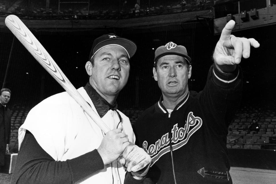 FILE - In this April 30, 1969, file photo, Detroit Tigers' Al Kaline has a baseball bat shouldered as he shares a moment with Washington Senators manager Ted Williams, in Detroit. (AP Photo/File)