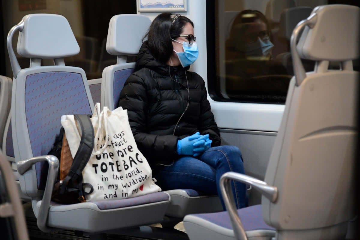 A woman wearing a face mask sits on a train at the Atocha Station in Madrid (AFP via Getty Images)