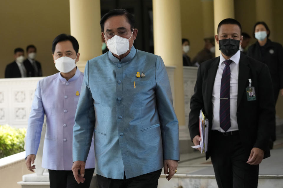Thailand Prime Minister Prayuth Chan-ocha, center, leaves after cabinet meeting at the Government House in Bangkok, Thailand Tuesday, Aug. 23, 2022. Thailand’s Constitutional Court on Monday received a petition from opposition lawmakers seeking a ruling on whether Prayuth has reached the legal limit on how long he can remain in office. (AP Photo/Sakchai Lalit)