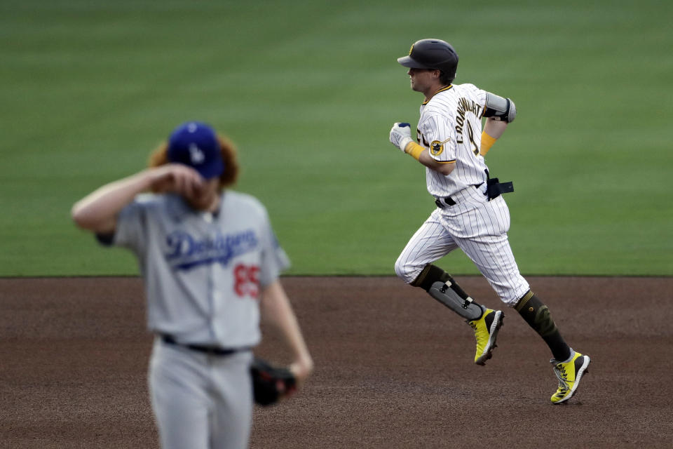 San Diego Padres' Jake Cronenworth, right, rounds the bases after hitting a home run off Los Angeles Dodgers starting pitcher Dustin May, left, during the fourth inning of a baseball game Tuesday, Aug. 4, 2020, in San Diego. (AP Photo/Gregory Bull)