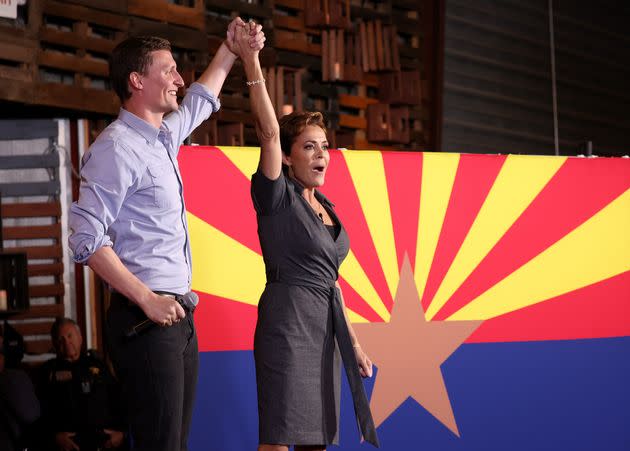 Arizona Republican gubernatorial candidate Kari Lake (right) and Arizona U.S. Senate candidate Blake Masters raise their arms at a campaign rally on Nov. 5 in Queen Creek, Arizona. (Photo: Justin Sullivan via Getty Images)