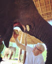 <p>Anderson Cooper lends a helping hand to some elderly elephants while visiting Myanmar, even jumping on one pachyderm's back to give it a bath. </p>